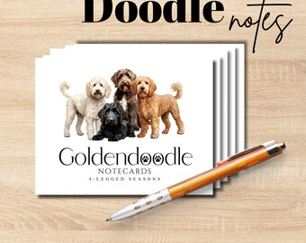 May include: A stack of white notecards featuring a graphic of four Goldendoodle dogs in cream, black, brown, and golden colors. The text reads Doodle notes, Goldendoodle NOTECARDS, and 4-LEGGED SEASONS. An orange and silver ballpoint pen lies across the cards.
