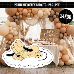 May include: A printable cutout featuring a cartoon dog with light yellow fur and black ears sleeping on a white cloud. The graphic has a thick black outline and is presented against a background of beige balloons and a wooden sign that reads Baby Shower.