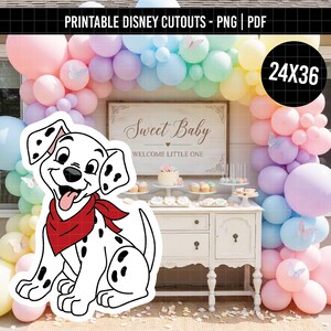 May include: A printable cutout of a cartoon dalmatian puppy with black spots and a red bandana around its neck. The puppy is positioned in front of a white wooden table decorated with a cake and treats, framed by a pastel balloon arch.