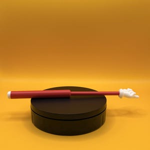 May include: A white ceramic mug with a black handle and the text "But First, Coffee" in a handwritten style. The mug is on a white surface. The mug is likely used for hot beverages.