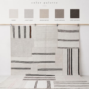 May include: A patchwork rug with a neutral color palette. The rug is primarily ivory with black and brown stripes. The image also displays a color palette with the following colors: ivory, light gray, warm beige, taupe brown, and deep brown.
