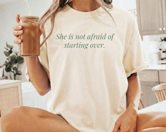 Koszulka „Ona nie boi się zacząć od nowa” | Odzież Resilience | Koszulka z motywującym cytatem | Koszulka Silna kobieta | Prezent na nowy początek | Koszulka Fearless