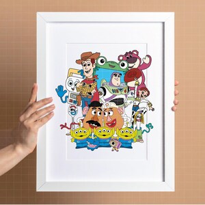 May include: A framed print featuring a colourful collage of characters from the animated movie Toy Story. The artwork includes Woody, Buzz Lightyear, Mr. Potato Head, and other recognisable characters. The print is in a white frame.