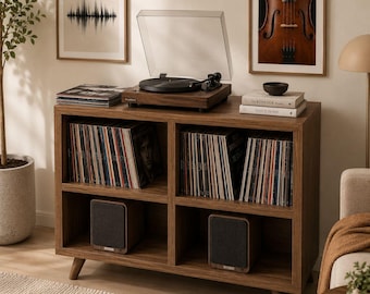 May include: A wooden record player and vinyl record storage cabinet. The cabinet has four compartments filled with vinyl records and two speakers. A framed picture of a violin hangs on the wall.