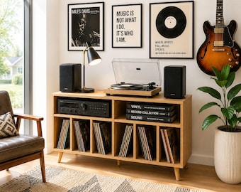 May include: A wooden record player console with a turntable, speakers, and a receiver. The console holds vinyl records and is decorated with framed art and a guitar. A black lamp sits on the console.
