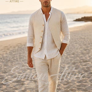 May include: A three-piece linen suit in a light beige color. The suit includes a button-up vest, long-sleeve shirt, and pants. The Simon Attire logo is visible in the upper left corner. The man is walking on a sandy beach.