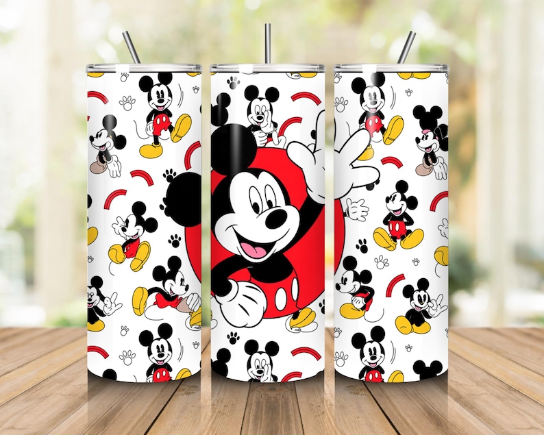 May include: Three stainless steel tumblers with a white background featuring a repeating pattern of Mickey Mouse in various poses. The central tumbler has a large Mickey Mouse design on a red circle. Each tumbler has a silver straw.