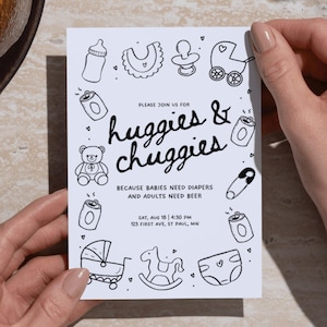 May include: A white rectangular invitation card with black line art illustrations of baby items and beverage cans. The text reads: PLEASE JOIN US FOR huggies & chuggies BECAUSE BABIES NEED DIAPERS AND ADULTS NEED BEER SAT, AUG 18 | 4:30 PM 123 FIRST AVE, ST PAUL, MN