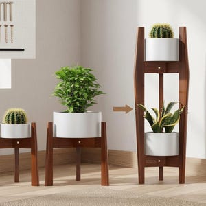 May include: A wooden plant stand with three tiers, each holding a white planter with a green plant. The stand is dark brown and has a modern design. The image also shows the hardware needed for assembly.
