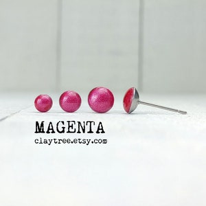May include: Four magenta colored clay earrings of different sizes. The largest earring is on a silver post. The text "MAGENTA claytree.etsy.com" is below the earrings.