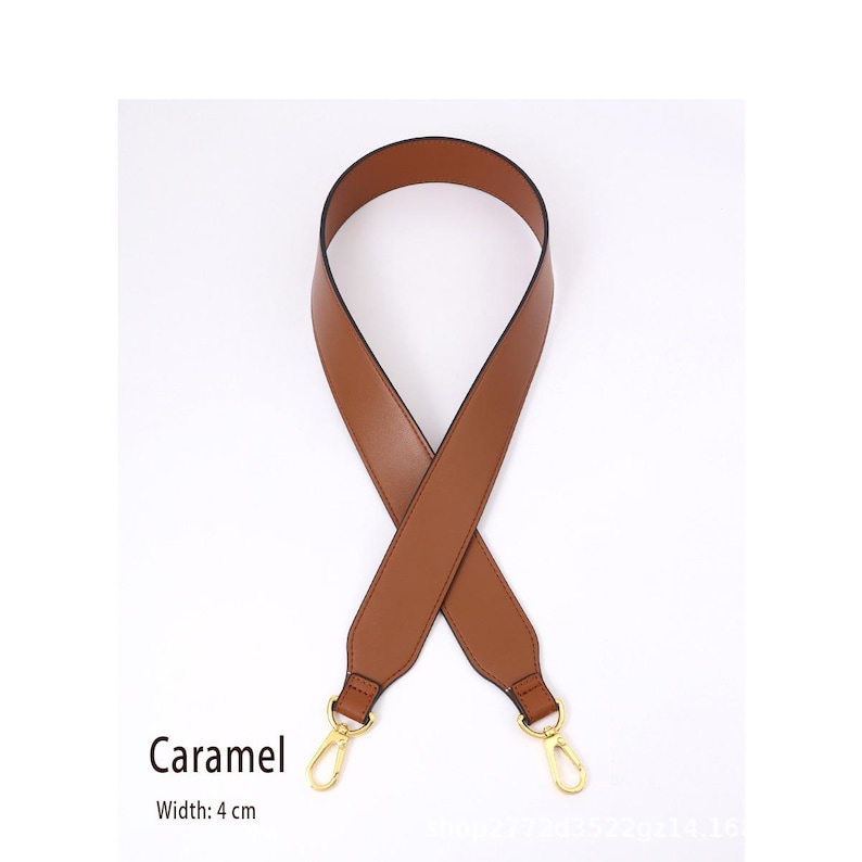 May include: A caramel-colored purse strap with gold-tone clasps. The strap is 4 cm wide and made of a smooth material. The word "Caramel" is printed on the image.