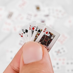 May include: A white ceramic mug with a black handle and the text "But First, Coffee" in a handwritten style. The mug is on a white surface. The mug is likely for hot beverages.