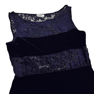 May include: A navy blue sleeveless dress with a velvet bodice and lace detailing. The dress has a sheer lace overlay at the neckline and a wide lace band across the midsection. The brand name "BCBG" is visible on a tag.