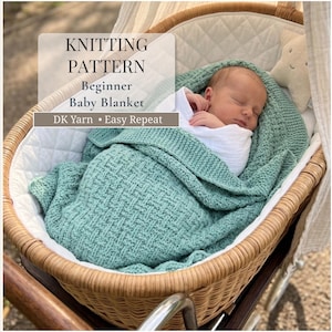 May include: A sage green knitted baby blanket with a textured basketweave pattern, wrapped around a sleeping infant. The text on the image reads: KNITTING PATTERN, Beginner Baby Blanket, DK Yarn • Easy Repeat. The blanket is inside a wicker bassinet.