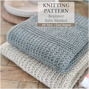 May include: Two knitted baby blankets, one gray and one beige, are stacked on top of each other. The top blanket is a light gray color, and the bottom blanket is a light beige color. The text on the image reads "KNITTING PATTERN Beginner Baby Blanket DK Yarn Easy Repeat."