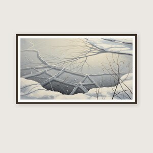 May include: Framed artwork depicting a winter landscape. The image shows a cracked, icy surface with snow and the silhouette of tree branches. The color palette is primarily cool tones of gray, white, and black.
