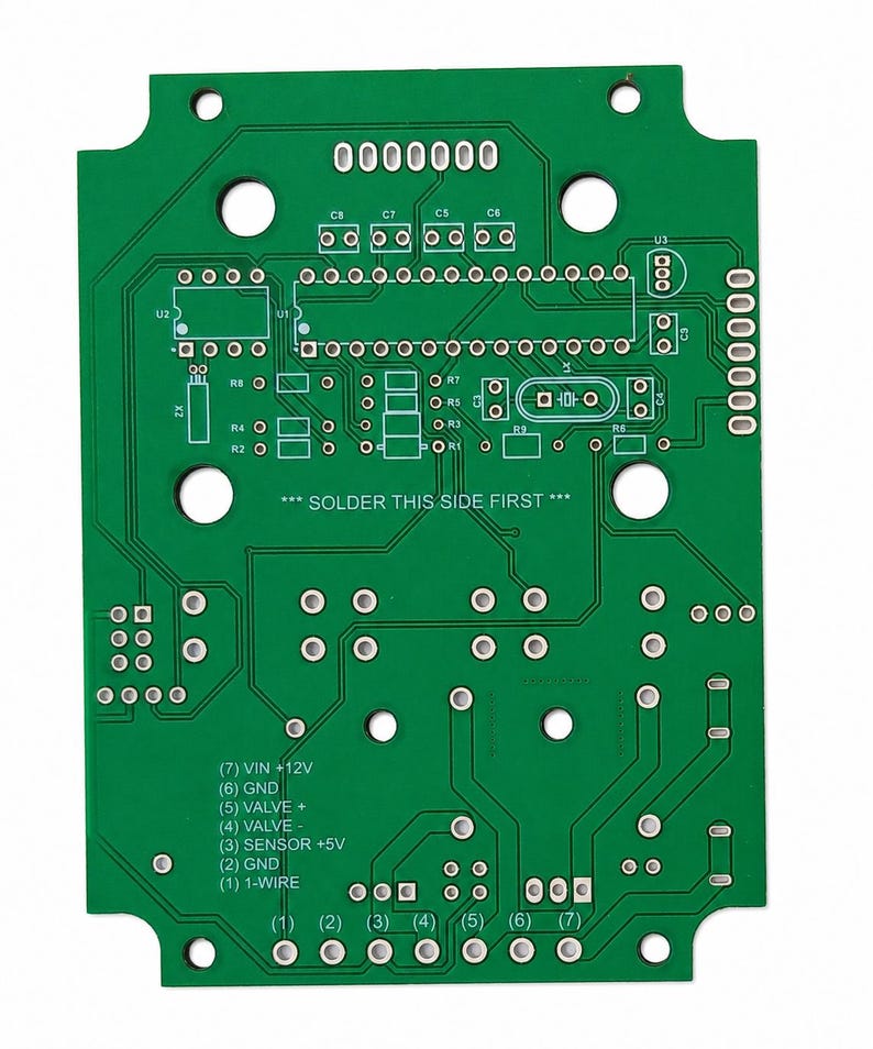 May include: A green printed circuit board featuring white silkscreen labels, including the text SOLDER THIS SIDE FIRST, various component outlines, and a numbered pinout list from 1 to 7 with labels like VIN +12V, GND, VALVE, and 1-WIRE.