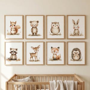May include: Eight framed watercolor prints of woodland animals, including a squirrel, bear, owl, rabbit, raccoon, deer, fox, and hedgehog. Each animal is depicted in a soft, pastel color palette, set against a white background.