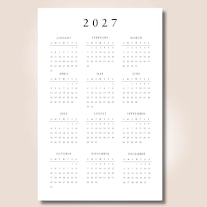 May include: A white 2027 wall calendar featuring a clean, minimalist layout with black text. The design displays all twelve months of the year, from January through December, arranged in a grid format with days of the week abbreviated as S M T W T F S.