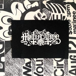 May include: A set of three ceramic mugs with a speckled, matte finish. The mugs are in shades of cream, light gray, and dark gray. Each mug has a simple, minimalist design, perfect for coffee or tea.