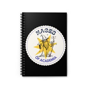 May include: Black spiral-bound notebook featuring a circular design with a wizard illustration. The design includes the text "Mages of Academia" in a blue and yellow color scheme. The wizard is depicted with a long beard and staff.