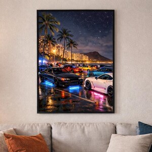 May include: A framed art print depicting a nighttime street scene with cars parked along a wet road. Palm trees and city lights illuminate the background. The cars have colorful neon lights, and the sky is dark with a few stars.