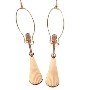 May include: A pair of cream-colored ceramic table lamps with gold metal bases and shades. The lamps have a pleated design and a simple, elegant style.