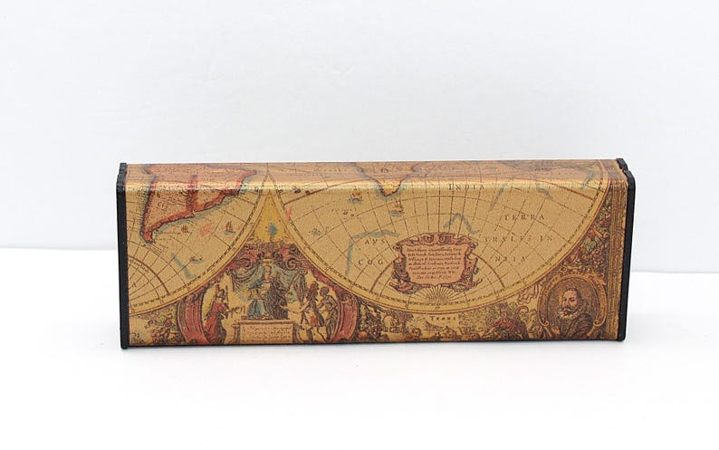 May include: A rectangular eyeglasses case with a vintage map design. The case features a tan background with a detailed map print in shades of brown, red, and gold. The edges are black.