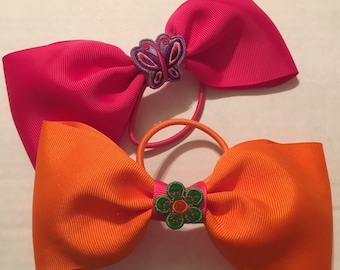 TWO adorable pink and orange tail less bows for cheer, dance, princess