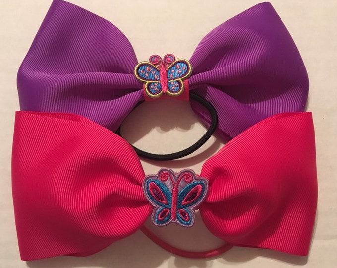 TWO adorable butterfly bows- purple and pink