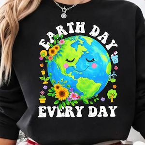 May include: A white ceramic mug with a black handle and the text "But First, Coffee" in a black, handwritten-style font. The mug is on a white surface.