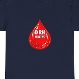 May include: Navy blue t-shirt with a red blood drop graphic. The graphic has the text "O RH NEGATIVE" in white. The t-shirt is a classic crew neck style.