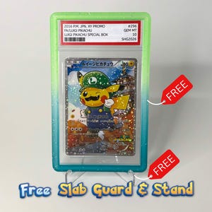 May include: A graded 2016 P.M. JPN. XY Promo #296 Luigi Pikachu trading card in a green and blue gradient protective slab. The card features a holographic illustration of Pikachu dressed as Luigi with a mustache, housed in a clear plastic case.