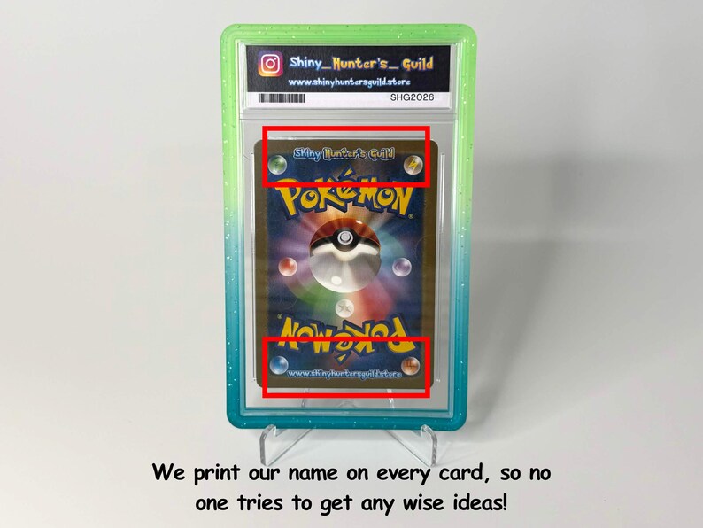 May include: A graded Pok&eacute;mon trading card encased in a clear plastic slab with a green gradient border. The card back features the Pok&eacute;mon logo, a central Pok&eacute; Ball graphic, and the text Shiny Hunter's Guild printed in the top and bottom red boxes.