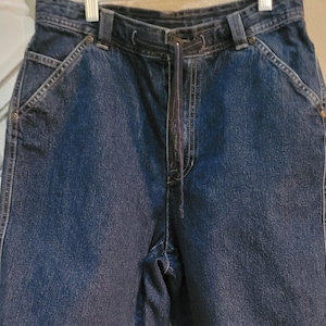 May include: Dark blue denim shorts with a drawstring waist and multiple pockets.