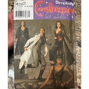 May include: Simplicity costume pattern for adults. The pattern features various costume designs, including long coats and fitted tops. The cover displays images of models wearing the costumes. The pattern sizes are RR 14, 16, 18, and 20.