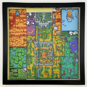 May include: A square, multi-layered wall art piece featuring a detailed, top-down pixel art map of a fantasy landscape. The map is divided into distinct colored regions including orange deserts, green forests, blue water, and gray stone structures.