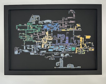May include: A framed wall art piece featuring a complex, multi-colored map layout set against a solid black background. The map consists of interconnected geometric shapes and pathways in shades of blue, green, yellow, and purple, all enclosed within a simple black rectangular frame.