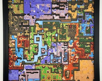 May include: A square framed wall art piece featuring a colorful, pixelated top-down map design. The artwork displays a complex grid of interconnected terrain sections in shades of blue, green, orange, purple, and tan, all enclosed in a black frame.