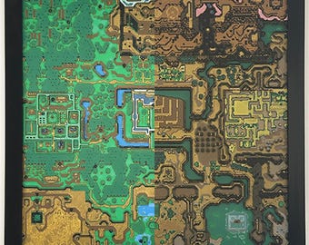May include: Framed artwork featuring a detailed map with green, gold, and brown terrain. The map includes blue water features and intricate pathways, set against a black frame. The artwork is a stylized representation of a video game map.