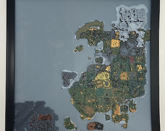 May include: Framed map art featuring a detailed, colorful depiction of a landmass. The map showcases a variety of colors, including green, yellow, and brown, set against a gray background. The artwork is encased in a black frame, suitable for wall decor.