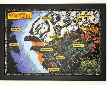 May include: A framed, multi-layered paper art map of Termina featuring labels for Great Bay, Zora Hall, Snowhead, Clock Town, Romani Ranch, Woodfall, Deku Palace, Ikana Valley, Stone Towers, and Goron Shrine in a black frame with a decorative border.