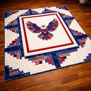 May include: A patriotic quilt featuring a central design of an eagle with outstretched wings, crafted from red, white, and blue fabric. The quilt has a white background with a red border and is surrounded by a border of blue and white stars and stripes.