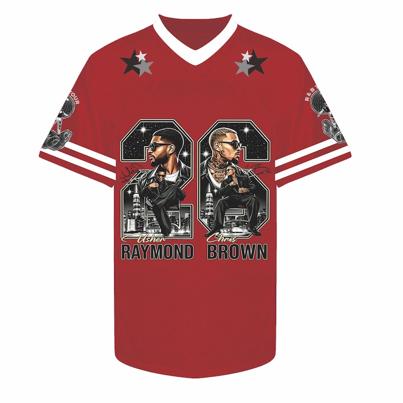 May include: A red V-neck jersey featuring white stripes on the sleeves and two star icons near the collar. The front displays graphic portraits of Usher Raymond and Chris Brown with their names printed below, set against a black background.