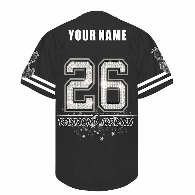 May include: A black short-sleeve jersey featuring the text YOUR NAME at the top, the number 26 in a silver diamond-like pattern in the center, and the name RAYMOND BROWN printed below with a decorative star graphic at the bottom hem.