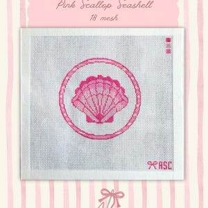 May include: A pink seashell design on a white canvas. The design is a scallop shell inside a circle, with the words "Pink Scallop Seashell" and "18 mesh" above it. The background is a pink and white striped pattern.