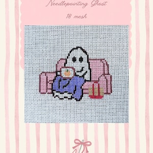 May include: A needlepoint canvas featuring a white ghost sitting on a pink couch, holding a mug with an orange design, wearing a blue sweater, and a red bag beside it. The text reads Needlepointing Ghost and 18 mesh on a pink background.