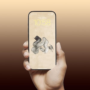 May include: A smartphone displays a unique abstract art wallpaper in a hand. The wallpaper features a black and white ink drawing on a beige background. The time is 10:58, Friday, May 26th. The phone has a black frame.