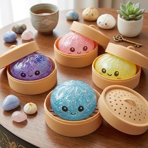 May include: A white ceramic mug with a black handle and the text "But First, Coffee" in a black, handwritten-style font. The mug is on a white surface.