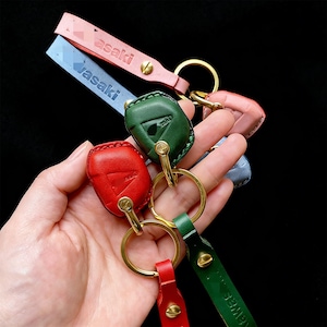 Op de afbeelding: Een witte keramische mok met een zwarte handgreep en de tekst "But First, Coffee" in een vetgedrukte, zwarte letter. De mok staat tegen een wazige achtergrond, wat een gezellige setting suggereert.